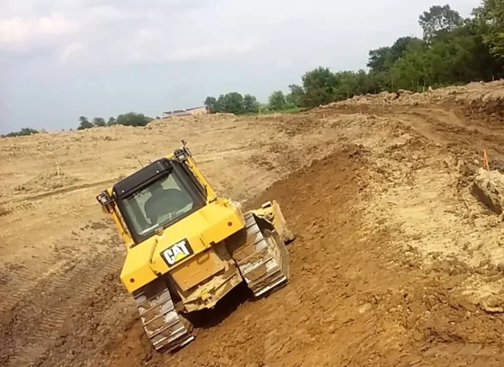 Yellow bulldozer on dirt.