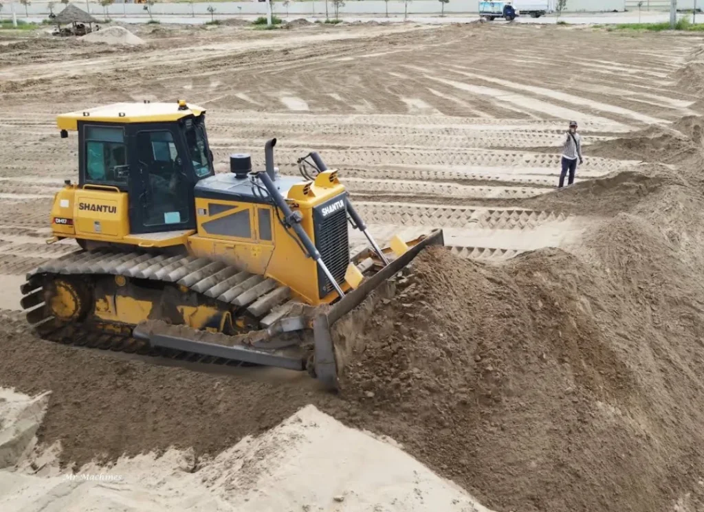Yellow bulldozer pushing dirt.