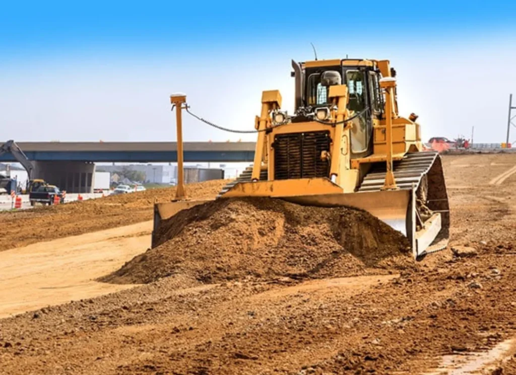 Yellow bulldozer pushing dirt.